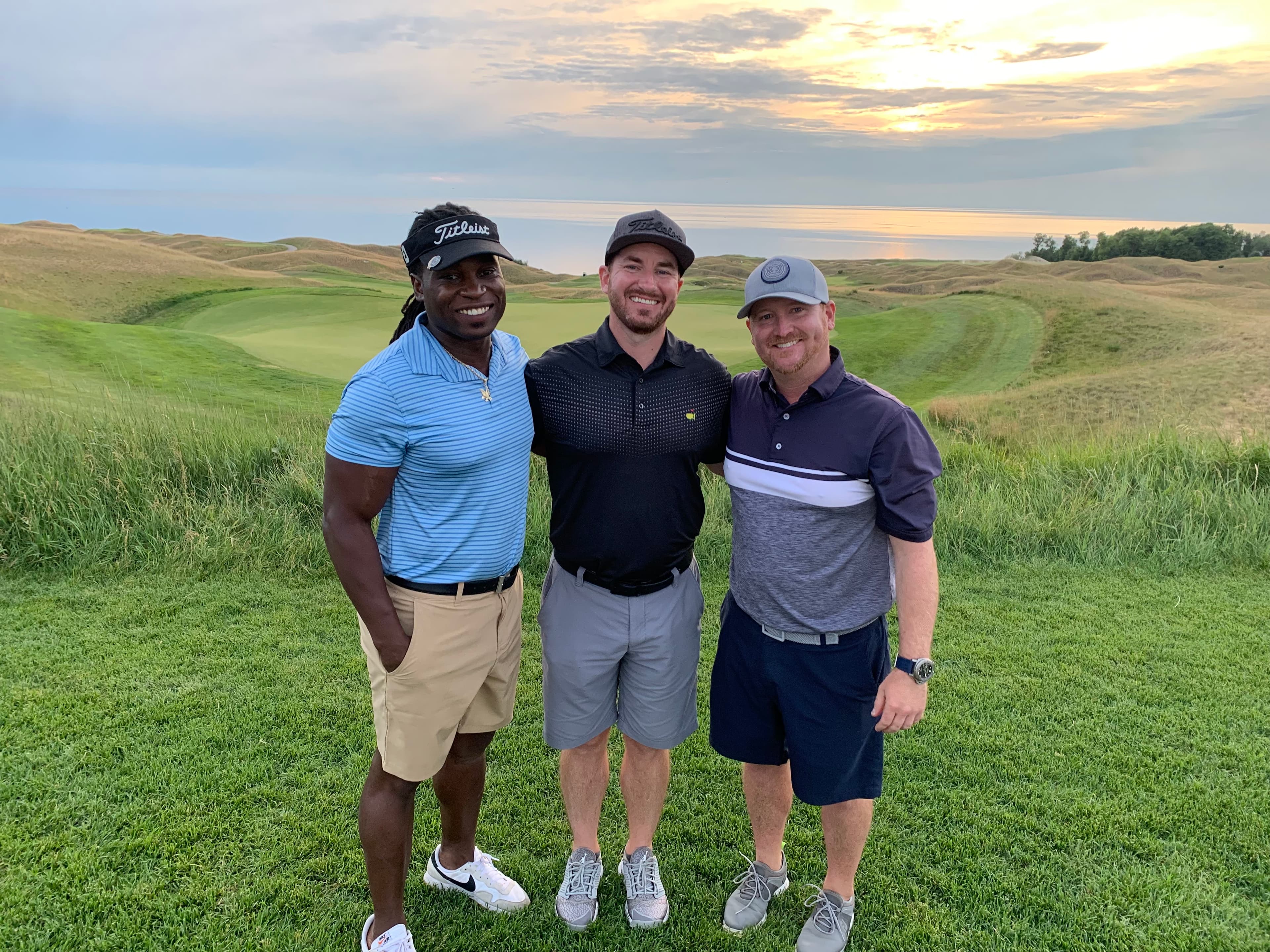 Three friends on a championship links course at sunset